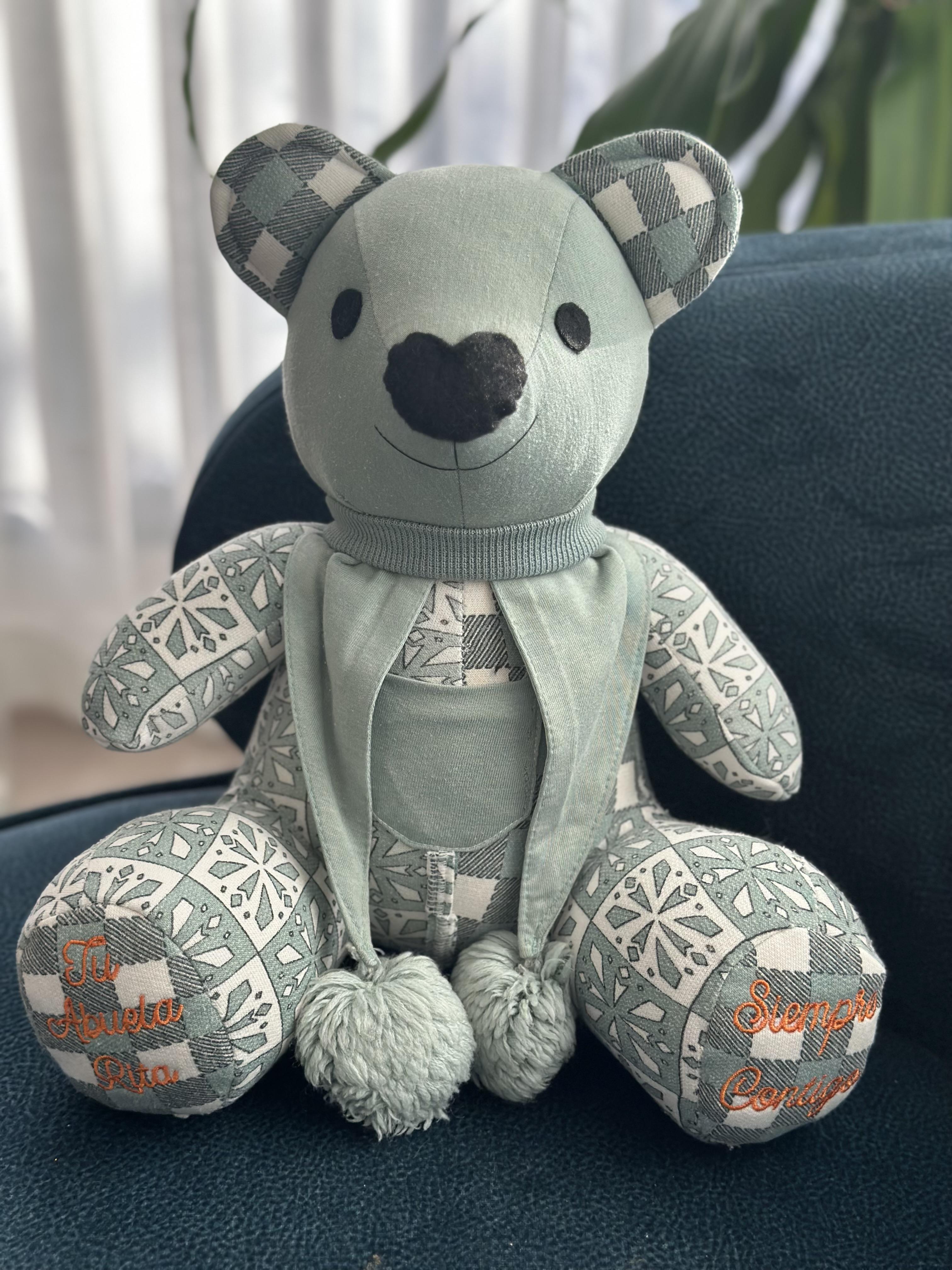 A brown teddy bear is posing for the camera.