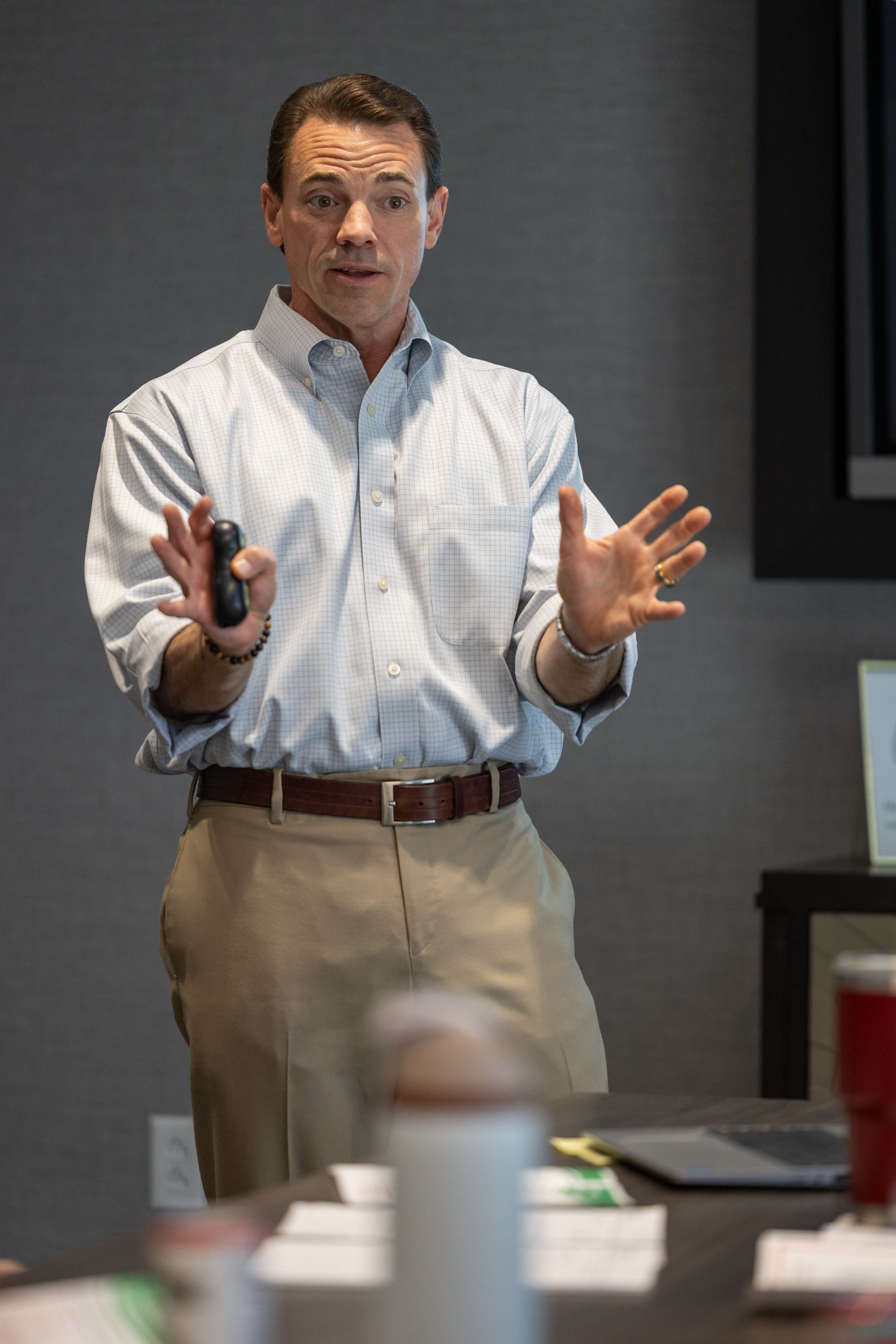 Graduates in red gowns taking a selfie together.