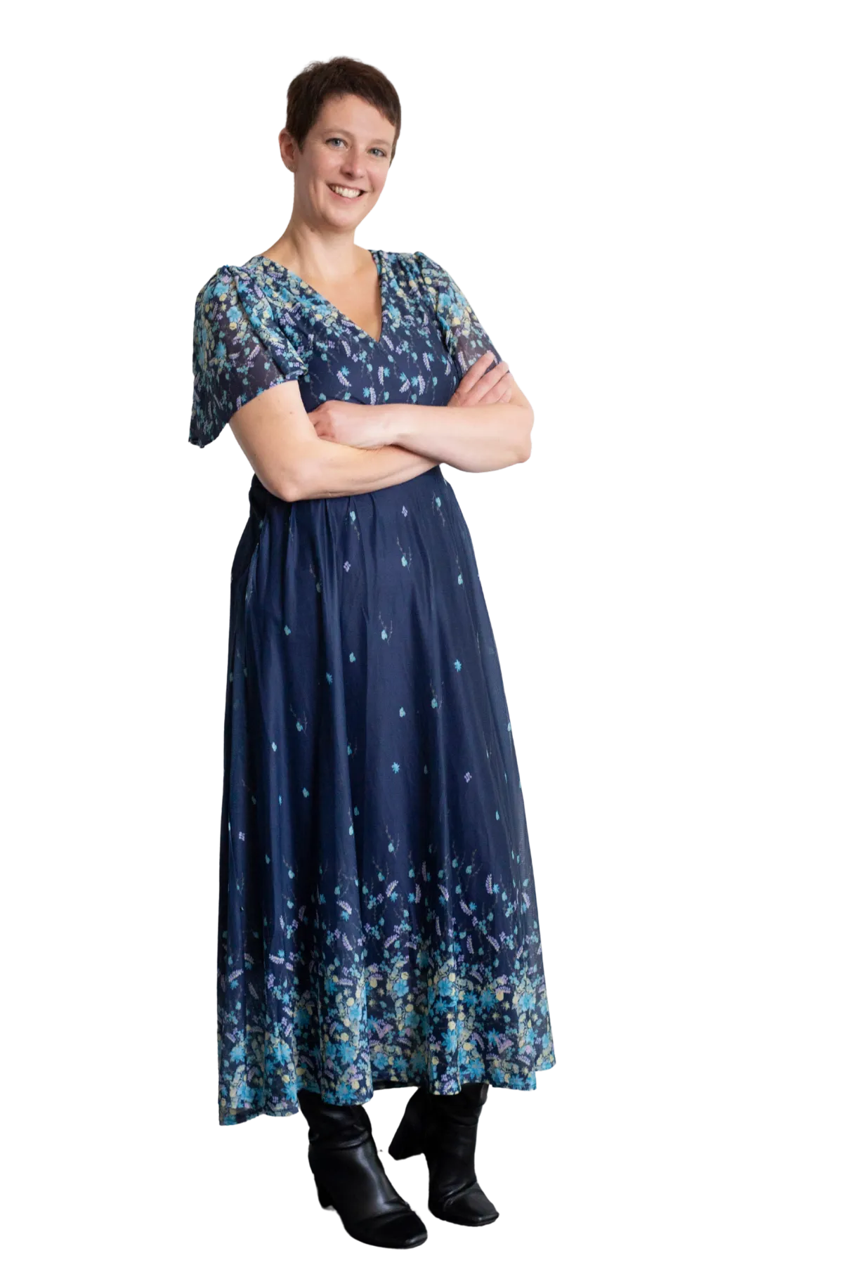 Picture of Charlotte standing and smiling with arms folded