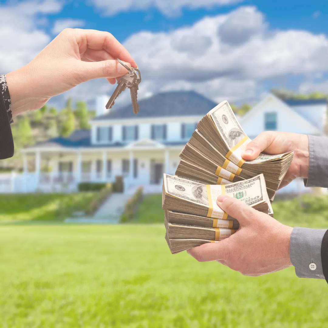 Homeowner handing over house keys in exchange for cash offer in front of home in Northeast Ohio