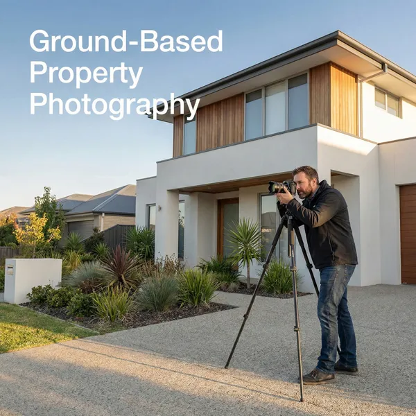 Professional property photographer standing outside a residential house with a camera mounted on a tripod, photographing the property during golden hour for real estate marketing.
