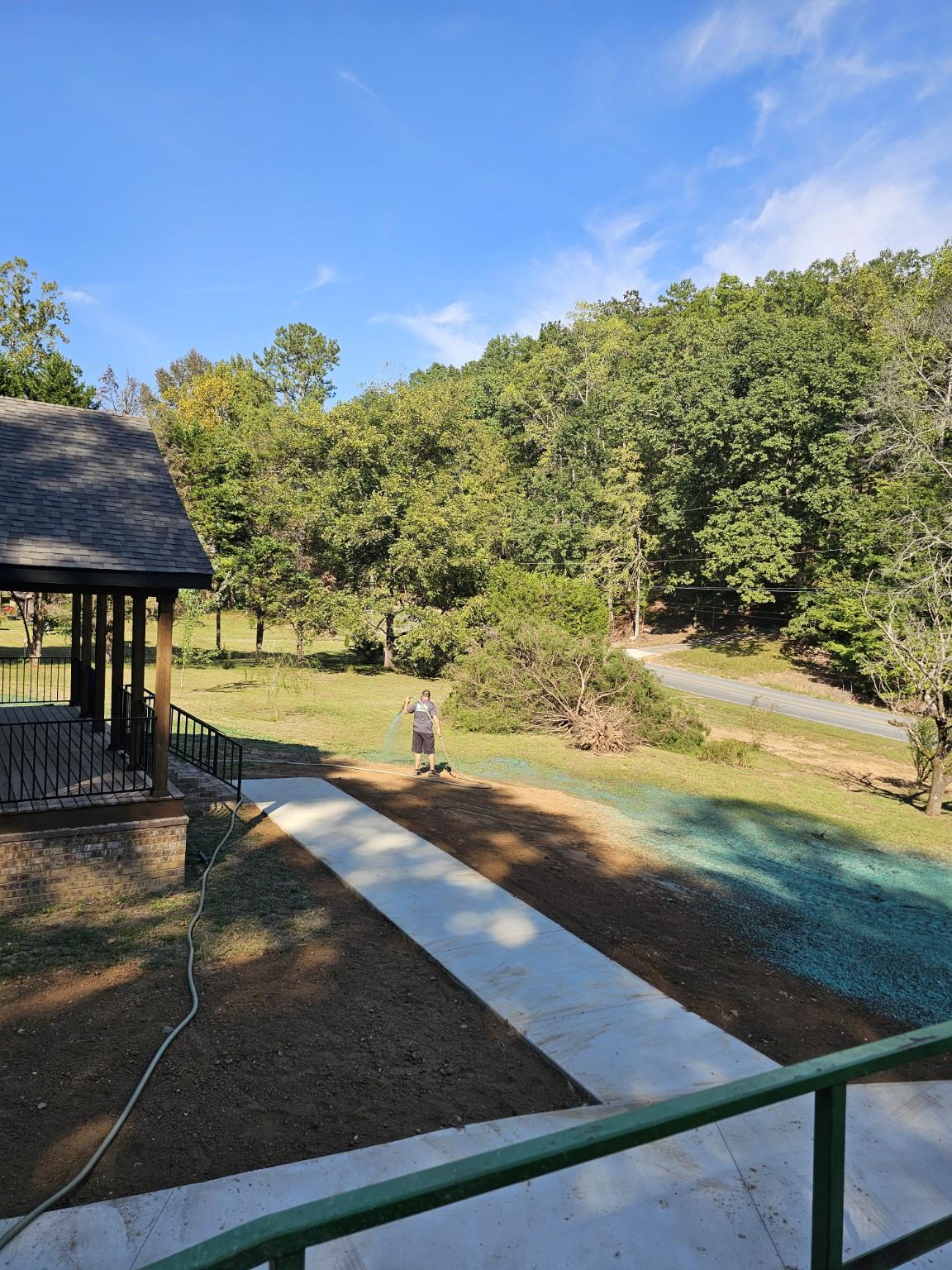 Worker spraying hydroseed on a front lawn in Rome, Georgia.