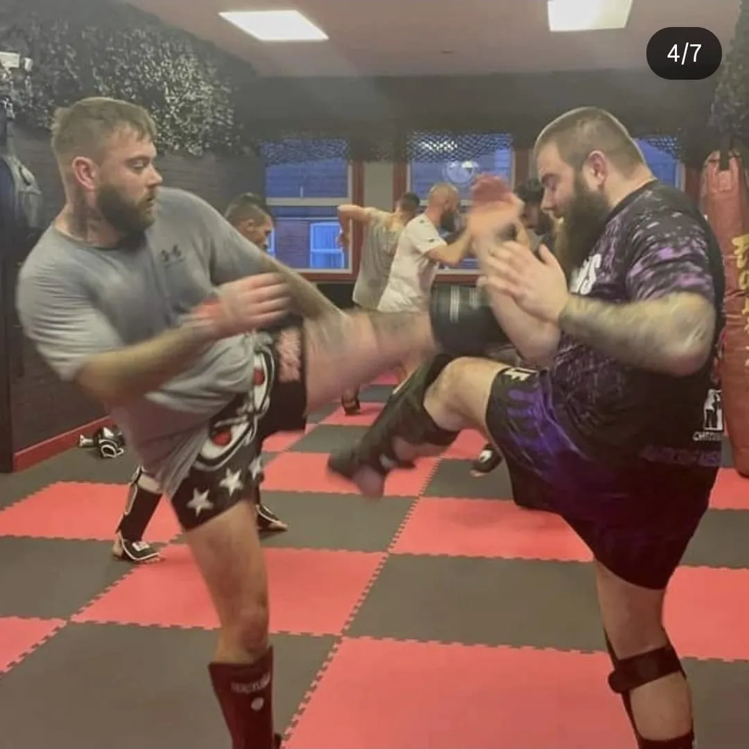 Combat sport founder cage-side coaching in arena