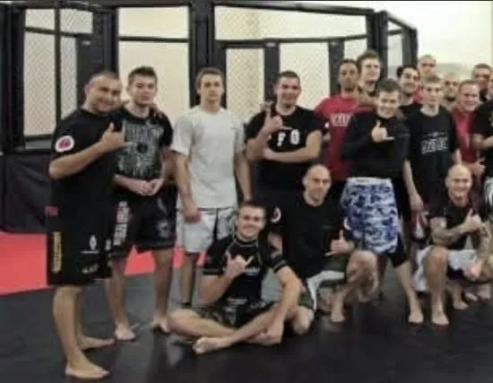 Combat sport founder cage-side coaching in arena