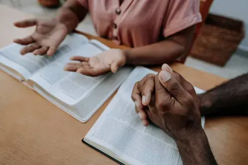 Honor and Clarity Coaching Ministry  - Rebecca & Bill Alderman - Group with hands on Bible asking questions, studying together