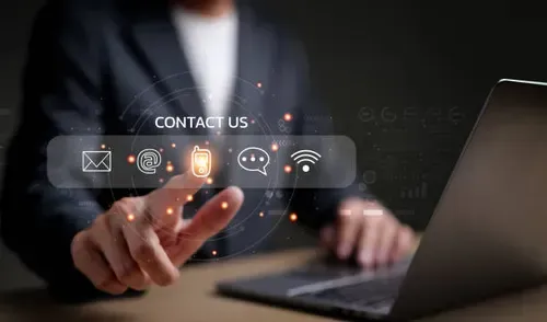 Honor & Clarity Coaching Ministry -Bill & Rebecca Alderman - Man sitting with laptop using finger to click his choice of contacting us for a conversation