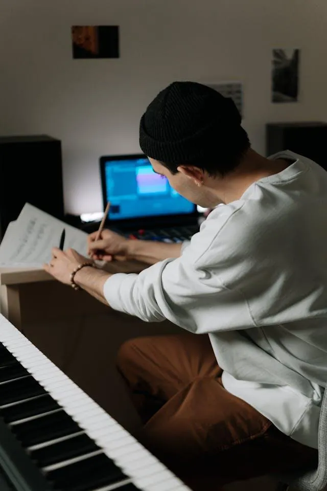 Piano, Music Score, Laptop with male image.