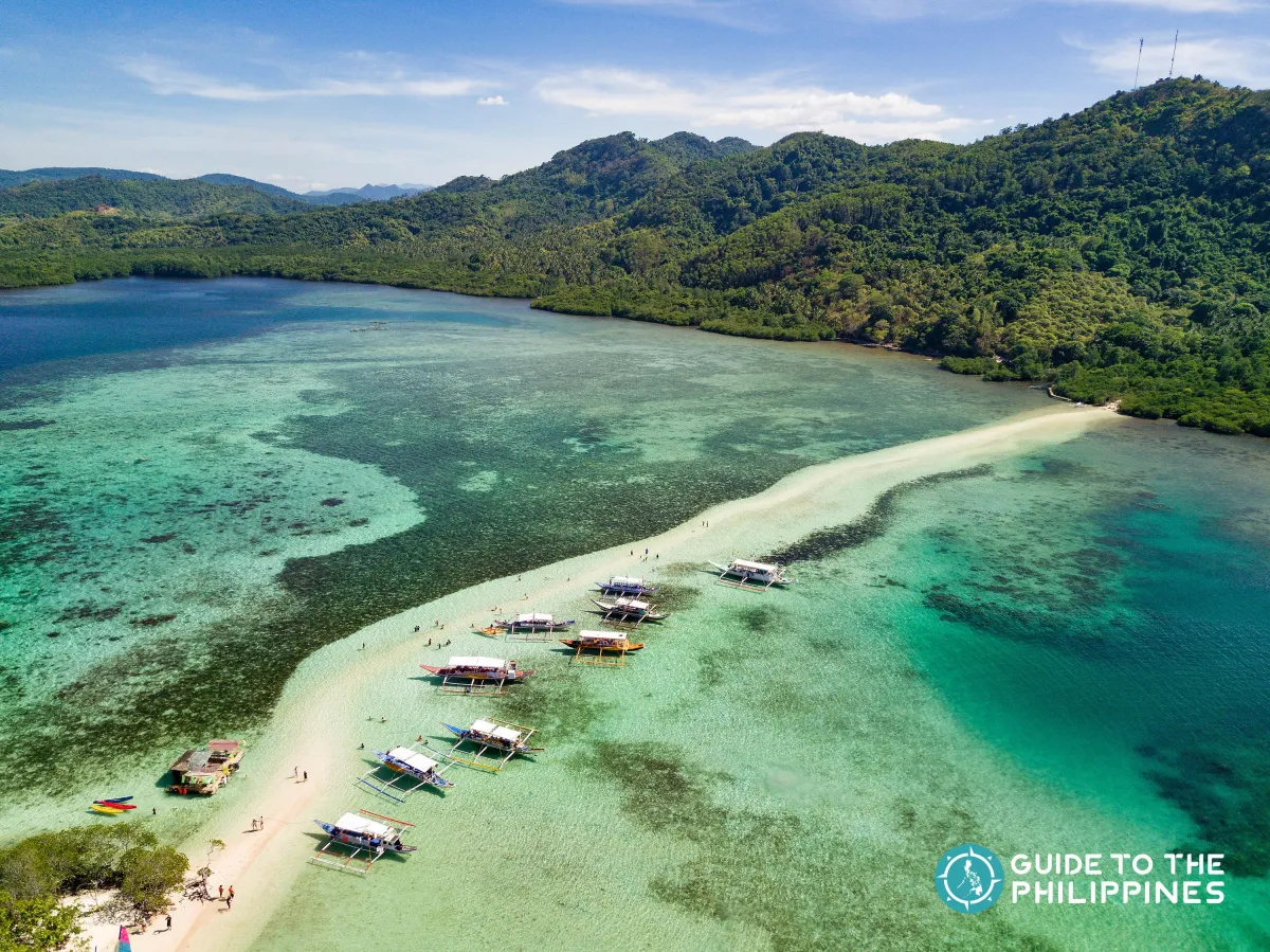 a couple of boats floating on top of a large body of water