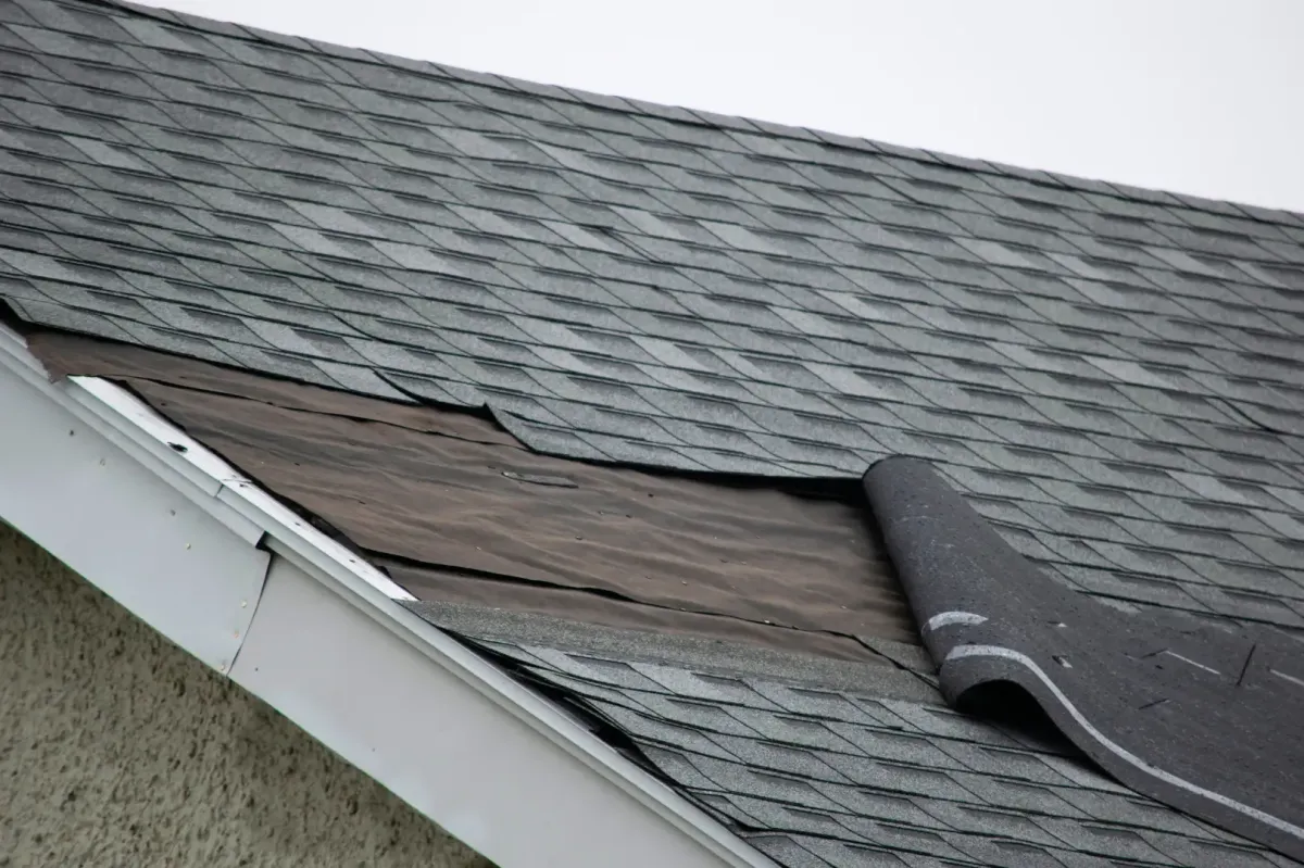 Roofer fixing shingles on residential home