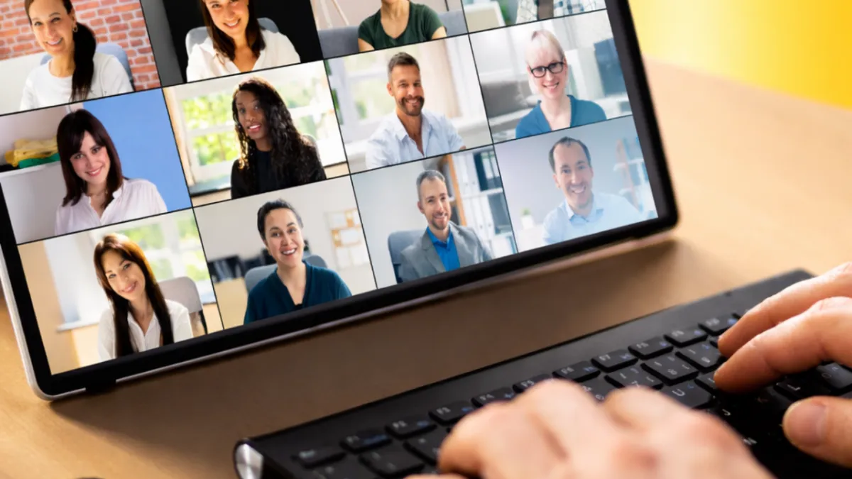 A cheerful real estate agent celebrating a successful referral in a modern office, holding a congratulatory email on a tablet. The background features a vision board with client photos and referral milestones, creating a sense of achievement and motivation.