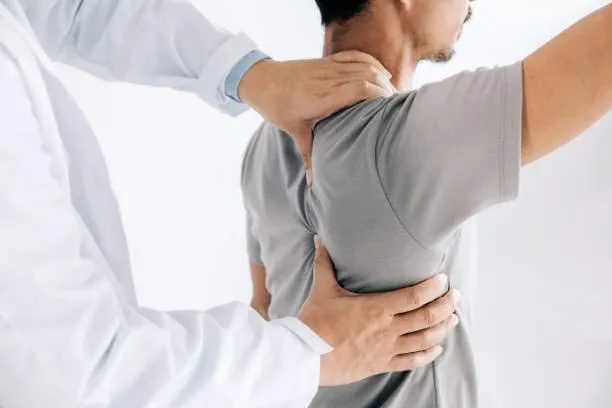 Chiropractor helping to fix a patient's neck and shoulder