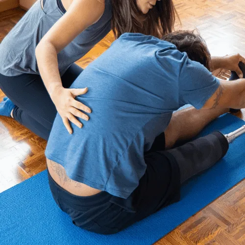 Chiropractor helping a patient relieve pain with rehabilitation exercise