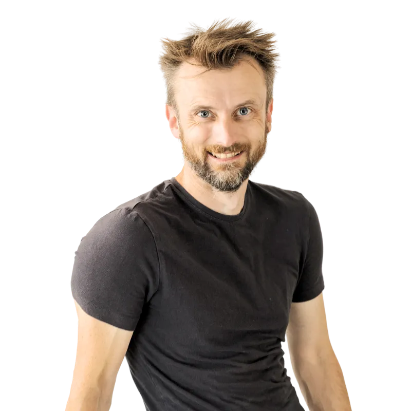Anthony Punshon, High-Performance Transformation Coach and Gym Owner, in a professional studio portrait leaning against a stool.