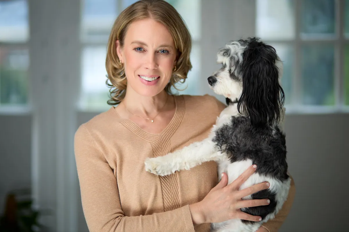 Dr. Anne Berkeley holding dog. 