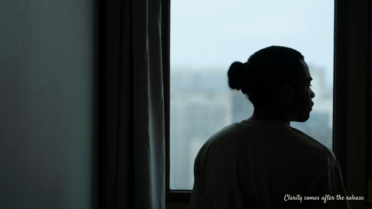 Person in a calm reflective state representing emotional healing and clarity after pain has been released through awareness.
