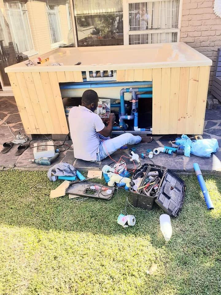 Norris servicing a jacuzzi and inspecting the pump and plumbing system in George, Western Cape.