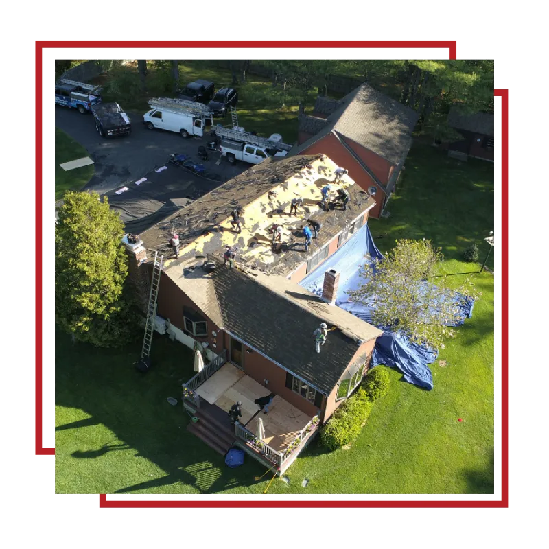 Roof repair crew working on a damaged home roof in Stoughton, MA