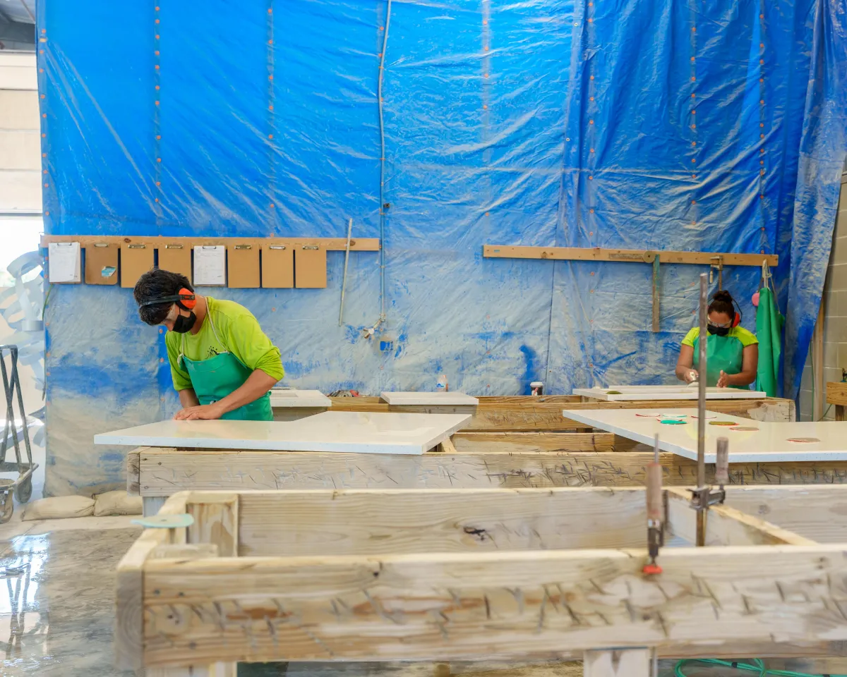 Quality first worker smoothing out a granite slab