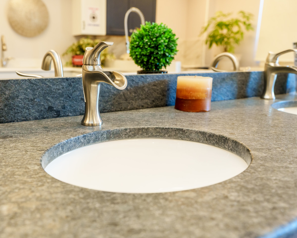 Quality first worker smoothing out a granite slab