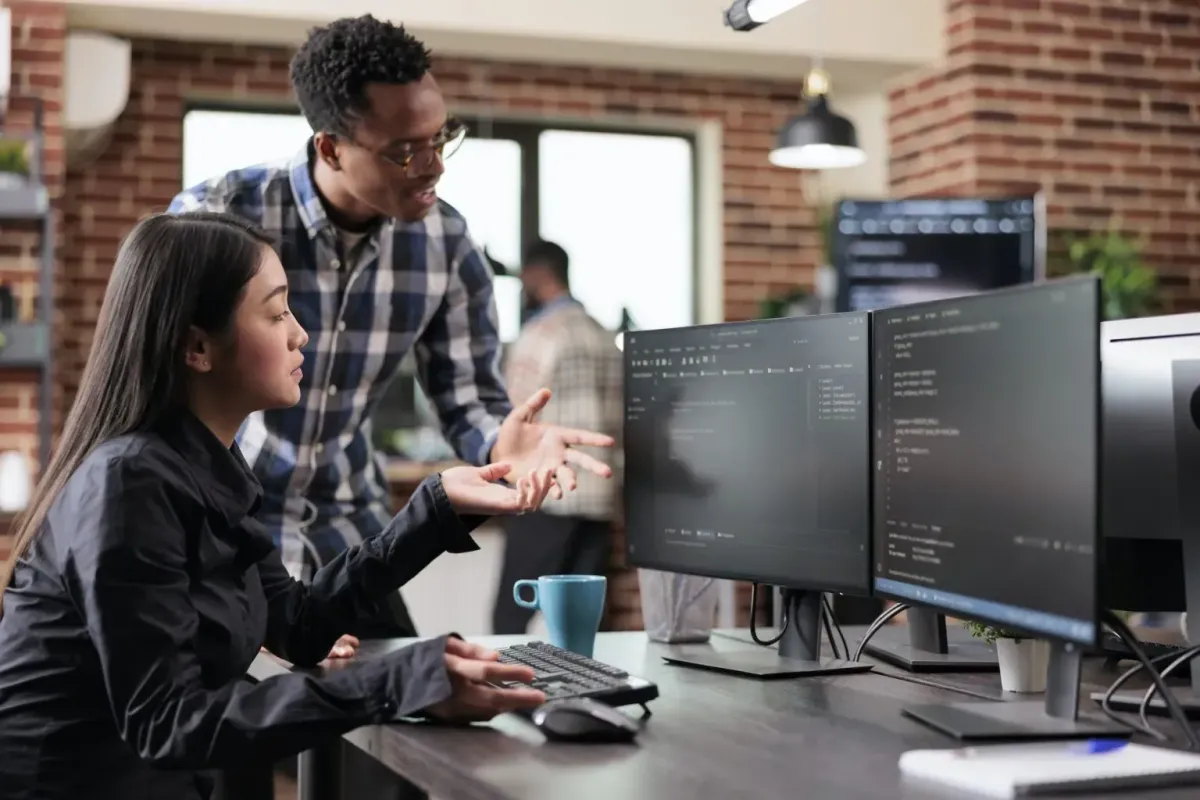 people looking at a computer problem