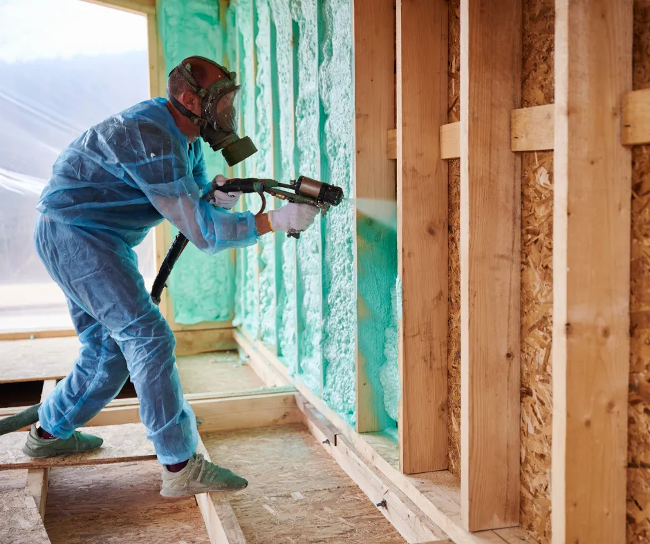 man spraying insulation