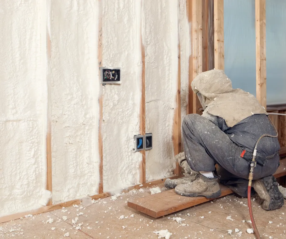 Spray foam insulation eing sprayed around an outlet