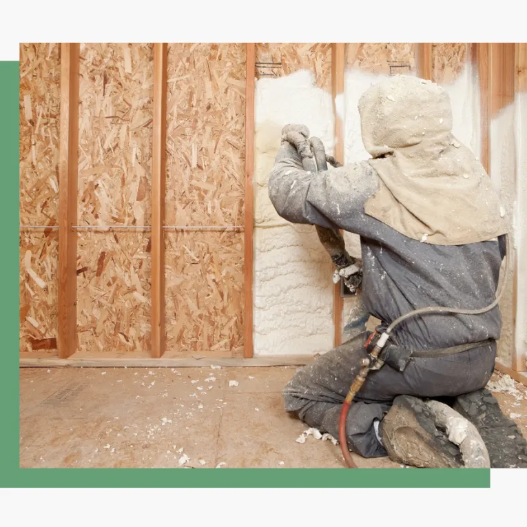 Spray foam insulation being sprayed by employee