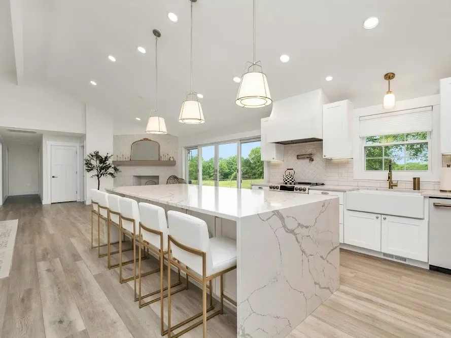 Remodeled Vista CA kitchen with sleek gray cabinets quartz countertops stainless steel appliances hardwood floors and large windows