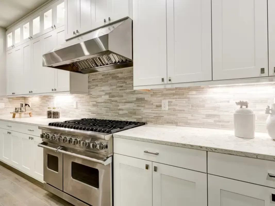 Renovated Vista California kitchen with sleek matte cabinets, stainless steel appliances, marble counters, hardwood floors, and natural light