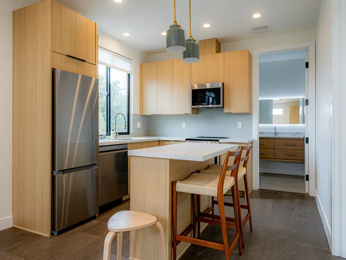 Remodeled modern kitchen in Vista CA with granite countertops, stainless steel appliances, and natural sunlight.