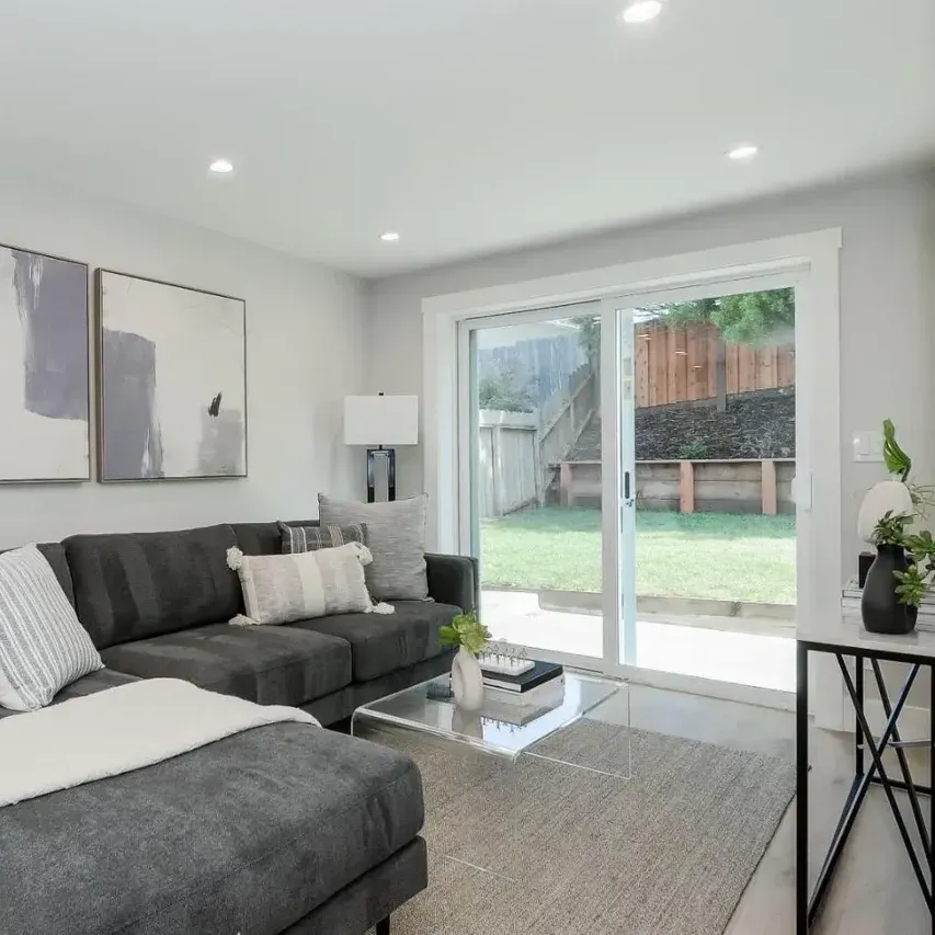 Bright renovated Vista CA kitchen and living space with modern design, sleek cabinetry, natural light, hardwood floors and stylish decor