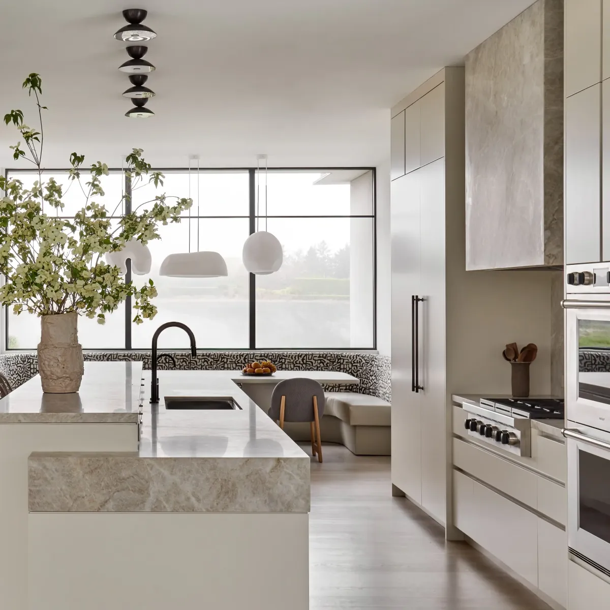 Custom modern kitchen in Vista California with natural wood cabinets stainless steel appliances marble island and natural light