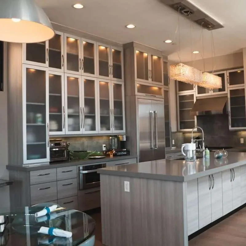 Modern Vista California kitchen with sleek matte cabinets, white quartz countertops, stainless steel sink, hardwood floors and natural light