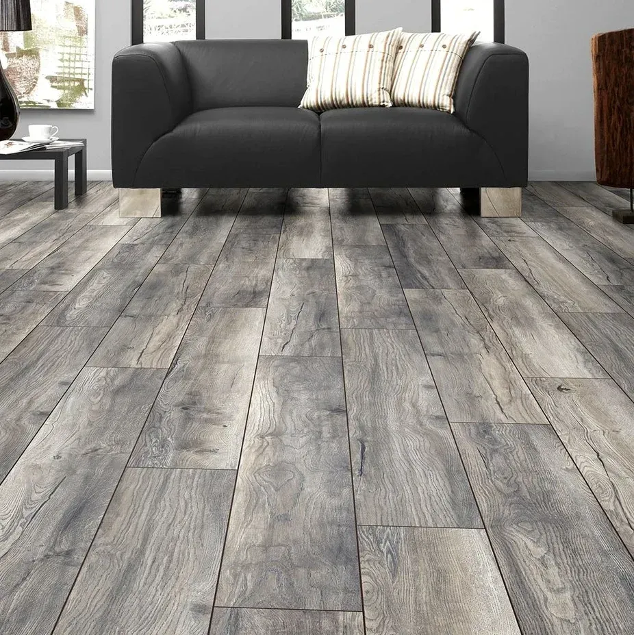 Close-up of stylish laminate flooring with detailed wood grain, natural tones, installed in a modern light-filled room in Vista California