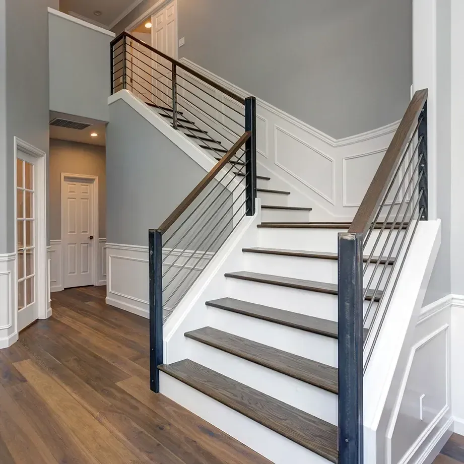 Modern renovated staircase with polished wood steps sleek metal railings natural light minimalist decor in Vista California