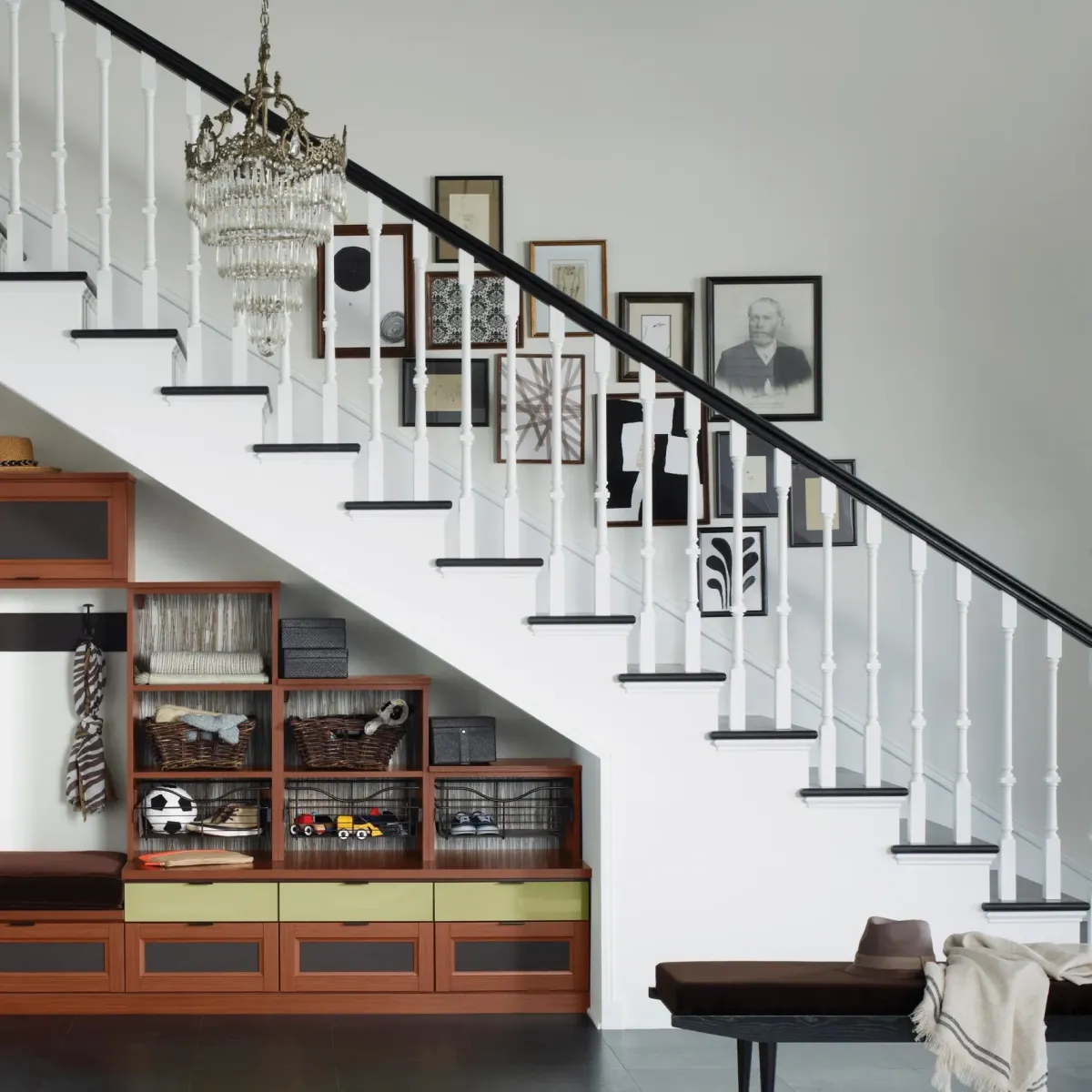 Remodeled Vista CA staircase with hardwood steps wrought-iron balusters and wooden handrail in a modern bright interior