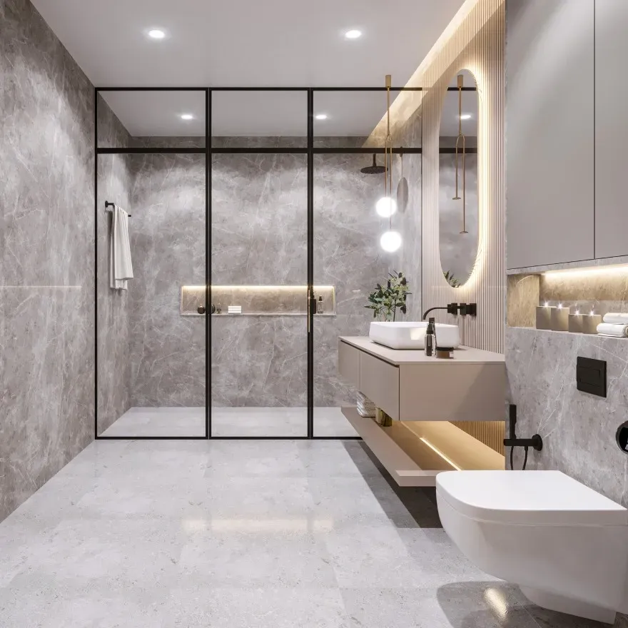 Smooth frameless glass shower door with chrome handles in a modern bathroom with marble tiles and polished fixtures