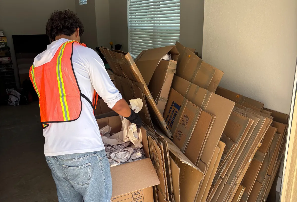 Guy Removing Cardboard Boxes and Packing/Packaging Material From A Garage