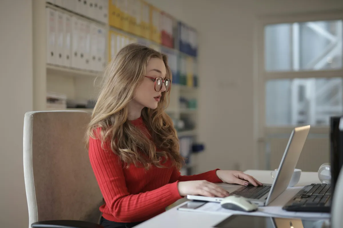 lady in red working on laptop