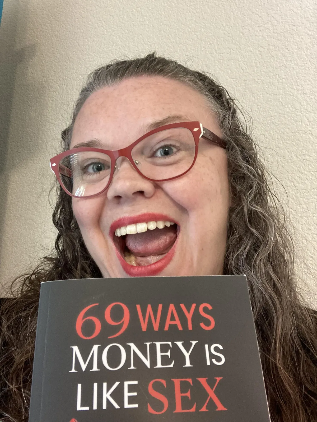 Excited Jen Perez with book 69 Ways Money is Like Sex