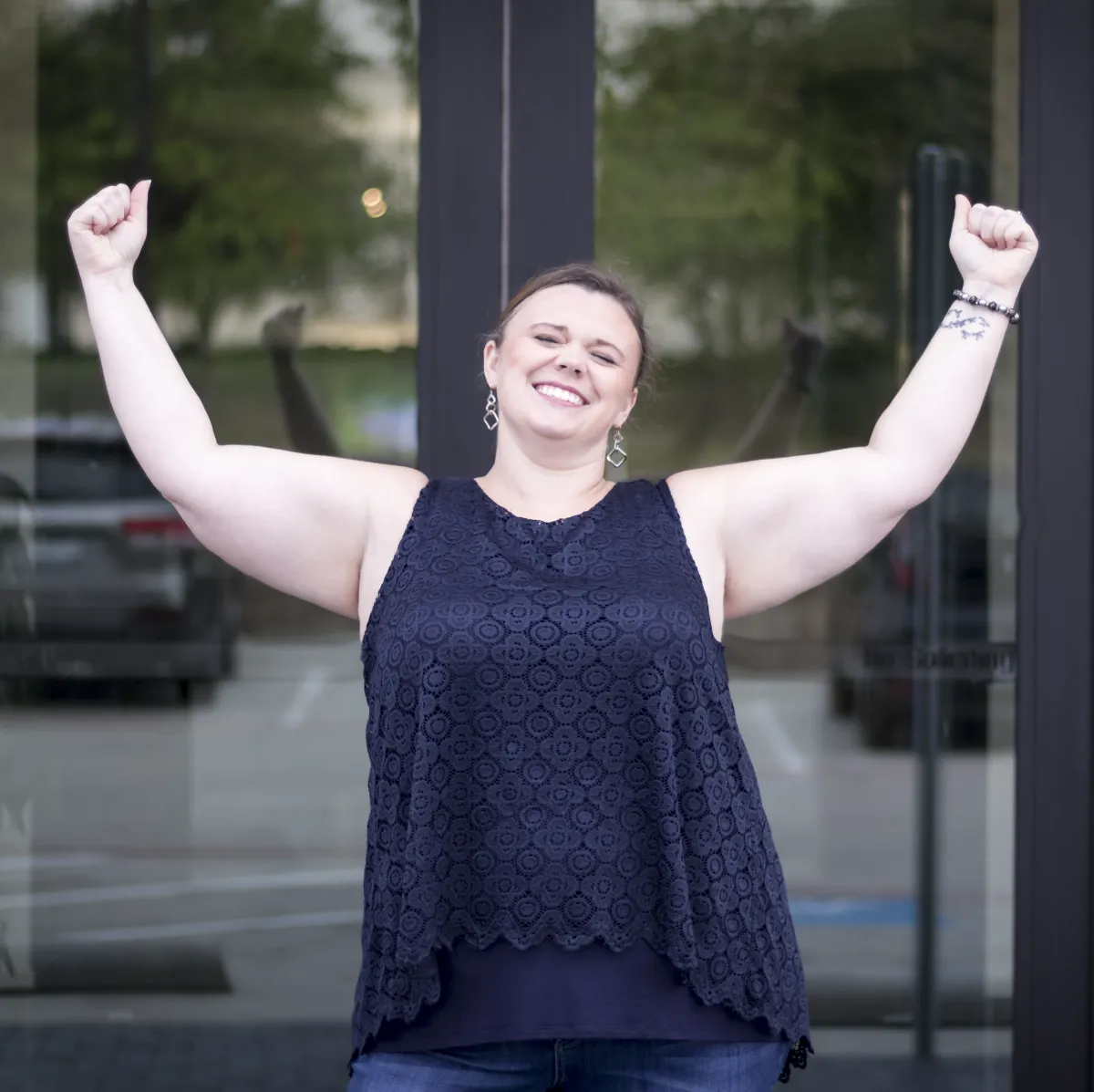 Jen Perez with hands thrown up in the air