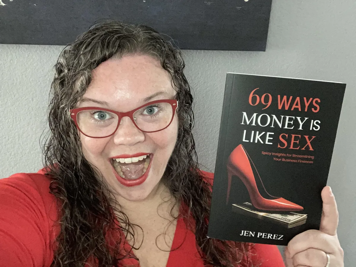 Excited Jen Perez with book 69 Ways Money is Like Sex