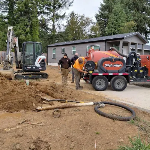 Econo Rooter Services crew with a vacuum excavator on a job site