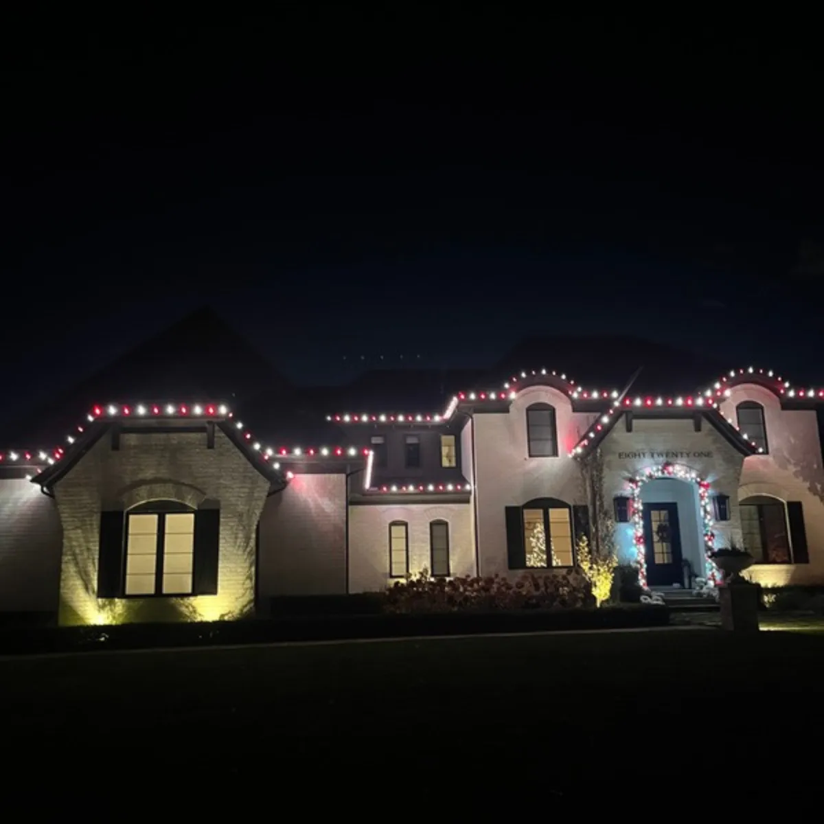 Full property Christmas light display with roofline, tree wrap and landscape lighting in Serling Heights, MI
