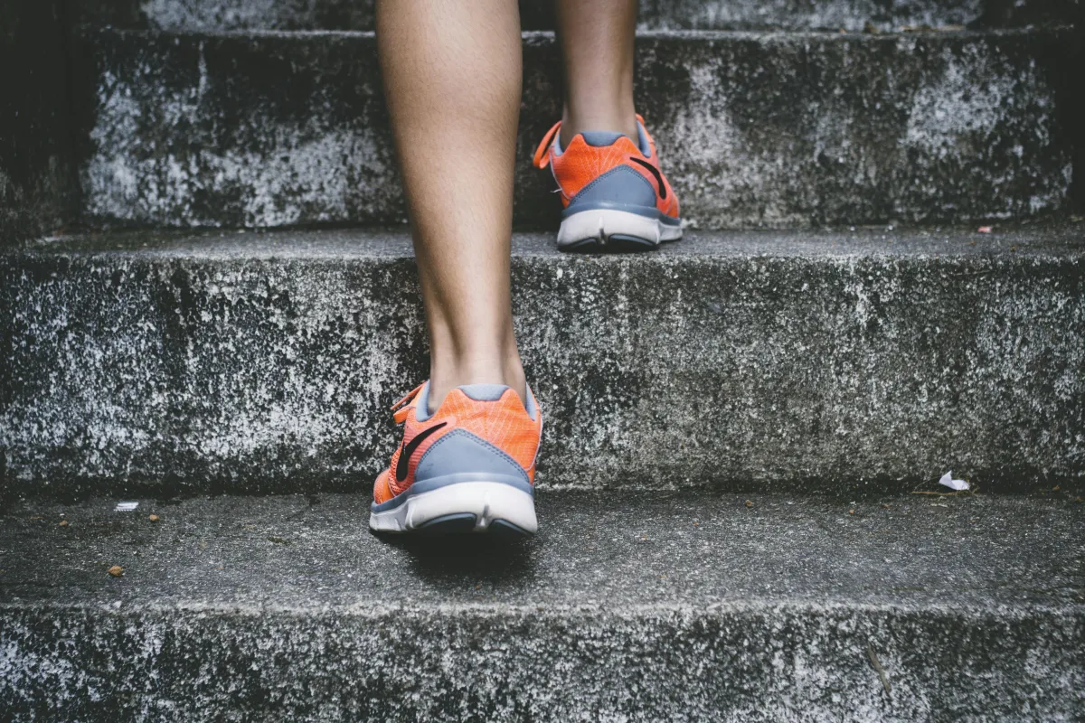 Running shoes on concrete steps representing building habits with ADHD through consistent routine