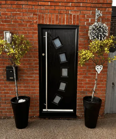 A composite front door that our paint spraying company sprayed black