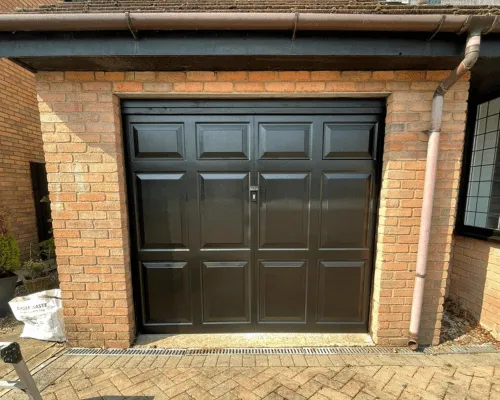 A garage door that we spray painted black