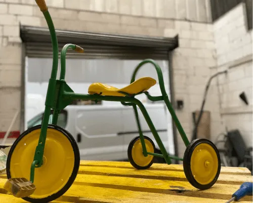 Photo of a child's bike we sprayed green and yellow