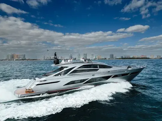 Luxury yacht cruising on water with skyline in background, showcasing sleek design and enhanced appearance, relevant to marine protection solutions.