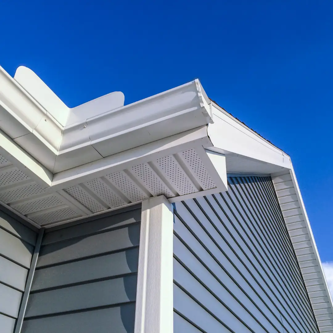 White gutters and soffit above blue siding
